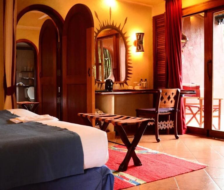 A room with arched doorways, a desk and a glass door open onto the terrace