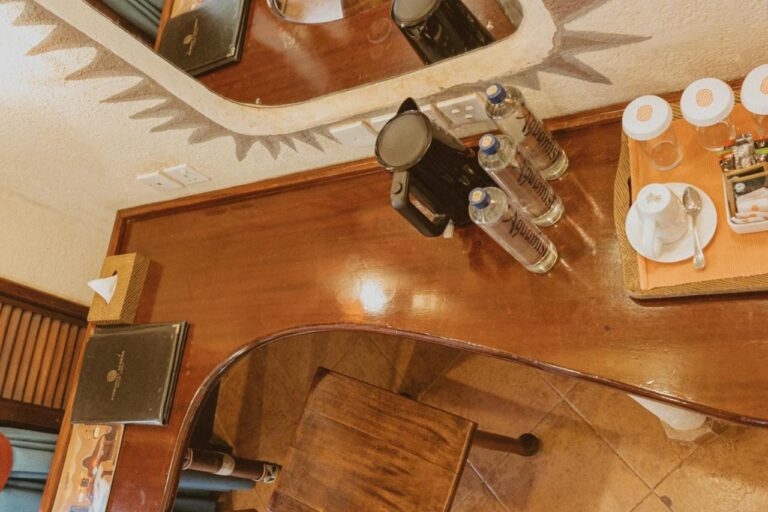 A desk seen from above, with a kettle, bottles of water and a tea tray