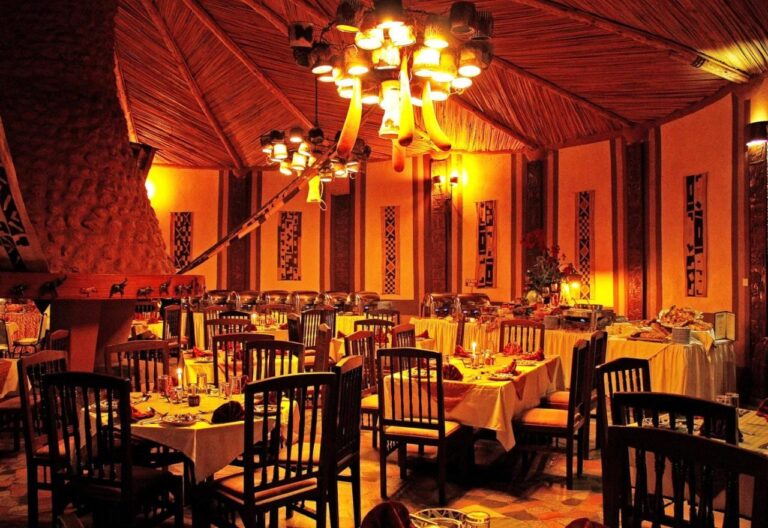 The restaurant in the evening, with yellow tablecloths and the chandeliers lit