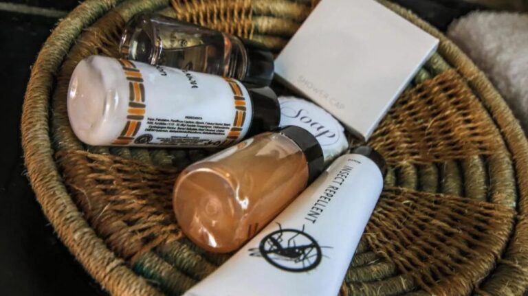 A woven basket filled with guest toiletries, including insect repellent