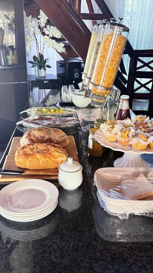 The breakfast buffet at Imbube Safari Lodge, with country loaves, muffins, jams and cereal dispensers