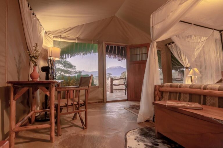 Inside a tent, with a desk, a fan and the door open onto Kilimanjaro