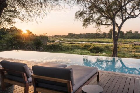 The infinity pool of the Kruger Gate Hotel above the Sabie River at sunset