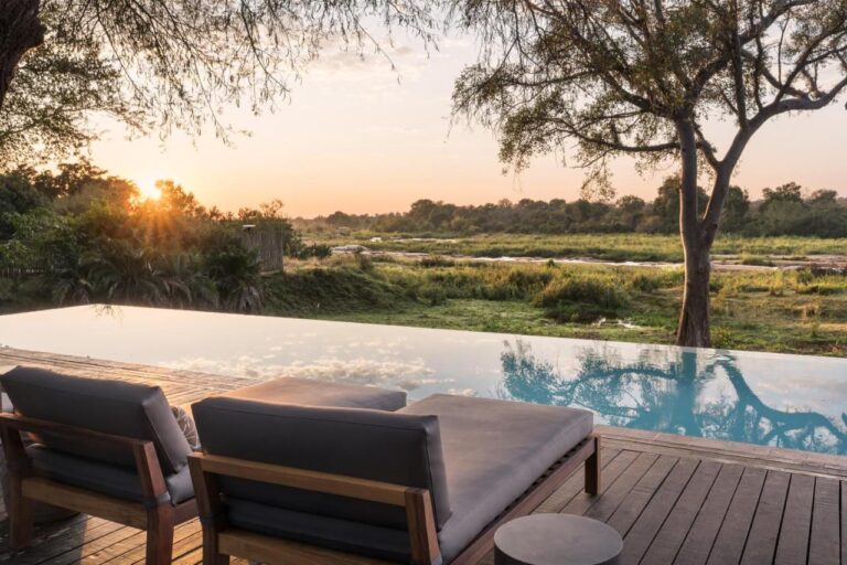 The infinity pool of the Kruger Gate Hotel above the Sabie River at sunset