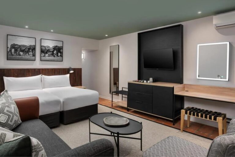 A Deluxe room with two twin beds, seen from the desk side