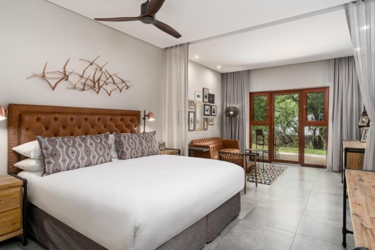 A room with leather furniture and a ceiling fan