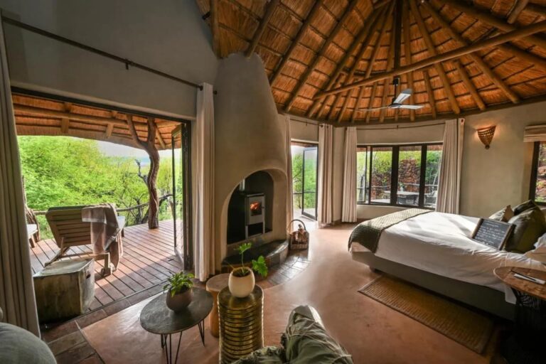 A suite opening onto a terrace facing the trees, with a wood stove and a double bed