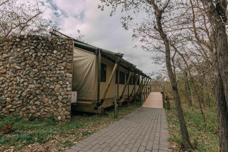 One of the lodge's tents, half stone and half canvas, at the end of a paved path
