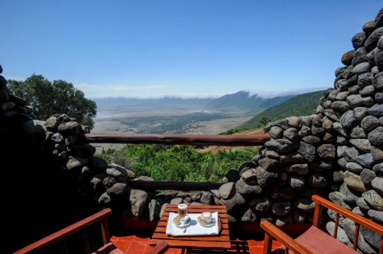 Two coffees on a balcony at Ngorongoro Serena Safari Lodge, between stone walls, above the crater
