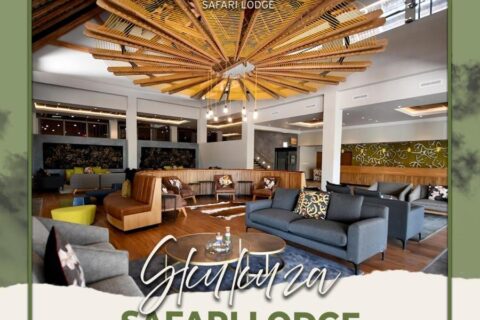 The lobby lounge of Skukuza Safari Lodge under its star-patterned wooden slat ceiling, with the lodge's name written across the image