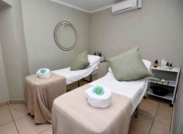 A spa treatment room with two massage tables