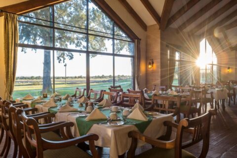 The restaurant at Sweetwaters Serena Camp, with its tables set in front of a large picture window over the plain