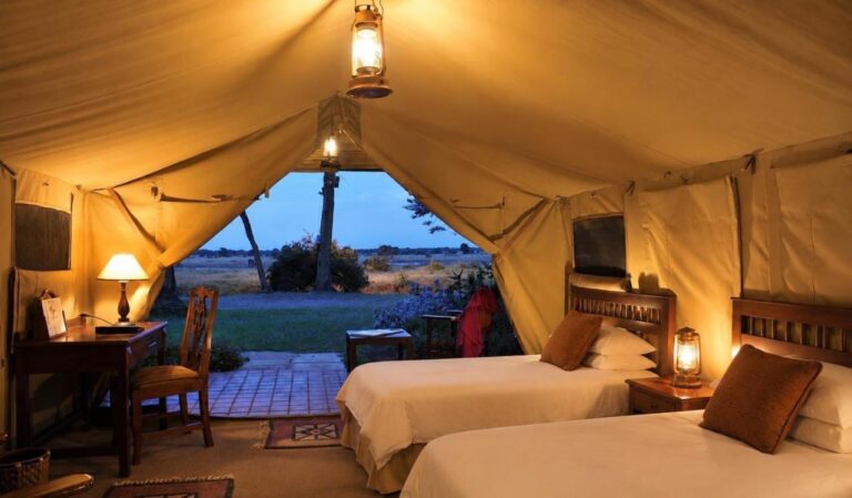 A twin tent open onto the plain, at dusk