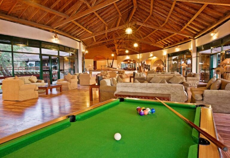 The lounge and its billiards table, under a wooden roof frame